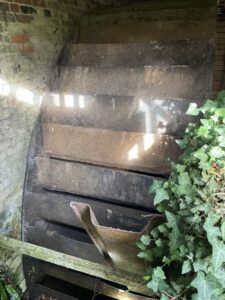 5.2 m breastshot waterwheel in a mill wheelhouse, seized and stationary; visible buckets and surrounding structures.